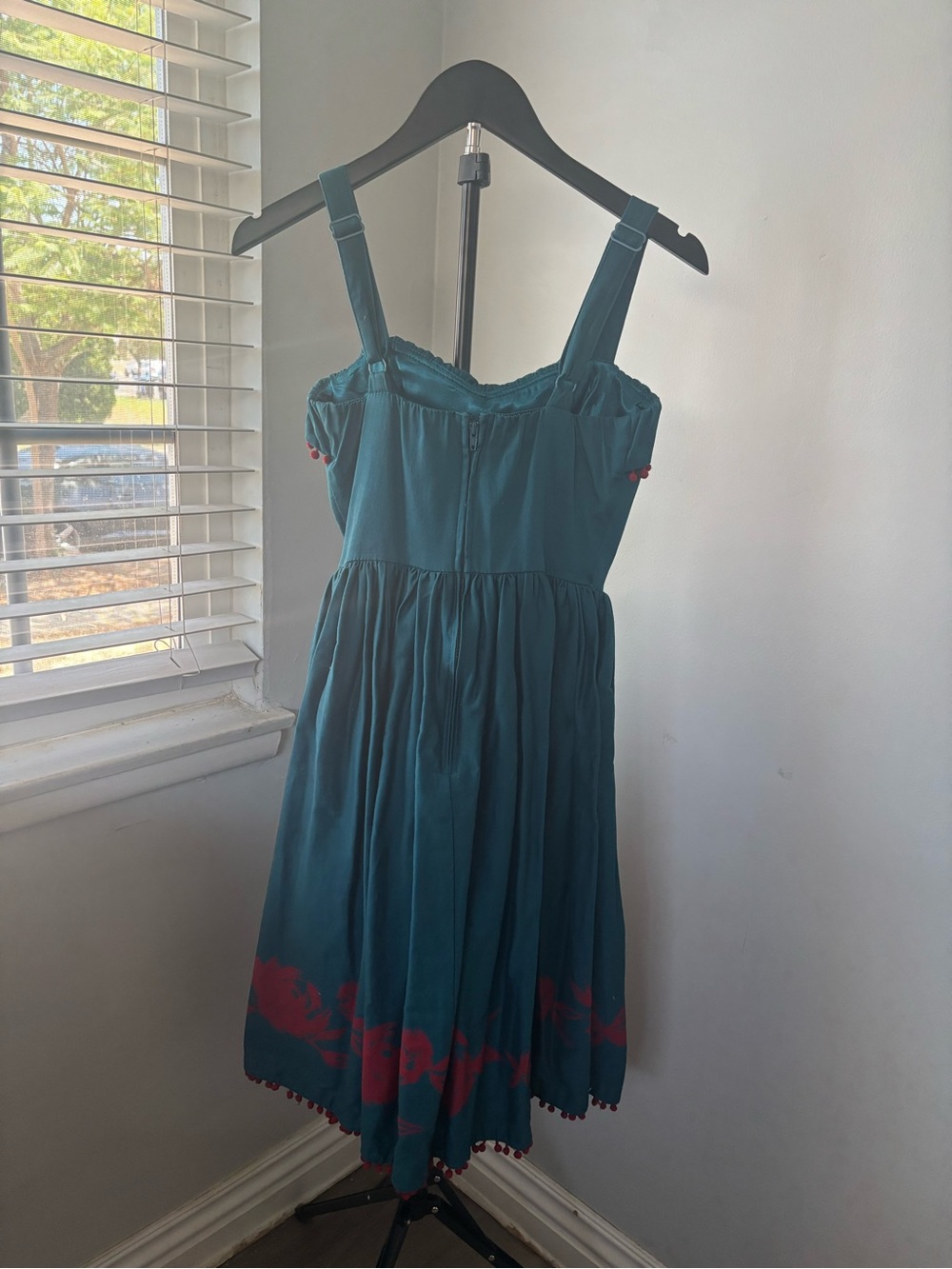 Pinup Couture Teal Sundress with Red Pom Trim and Floral Hem - Picture 2 of 3